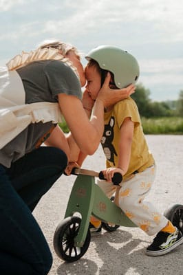 Mother fitting a Kinderfeets Helmet to her son